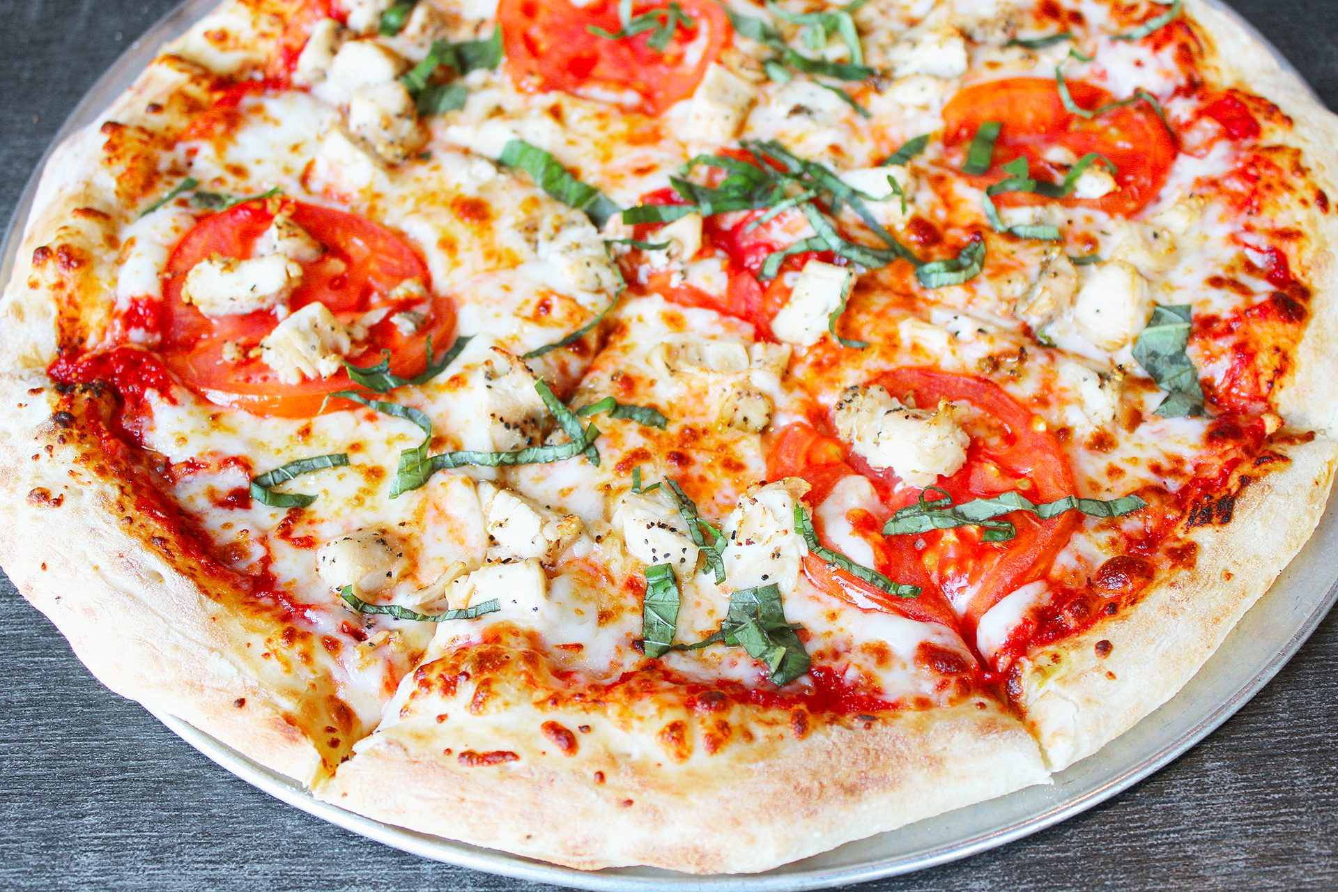 A fresh New York-style pizza at Parry's, loaded with toppings